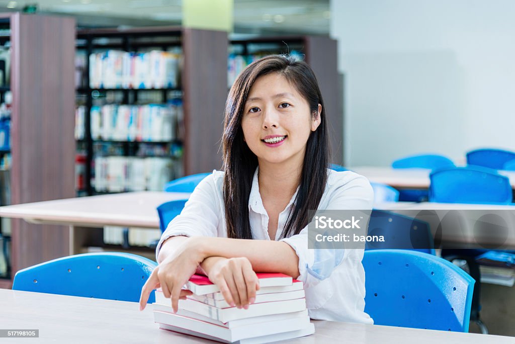 college student portrait of beautiful college student in the library. Adult Stock Photo