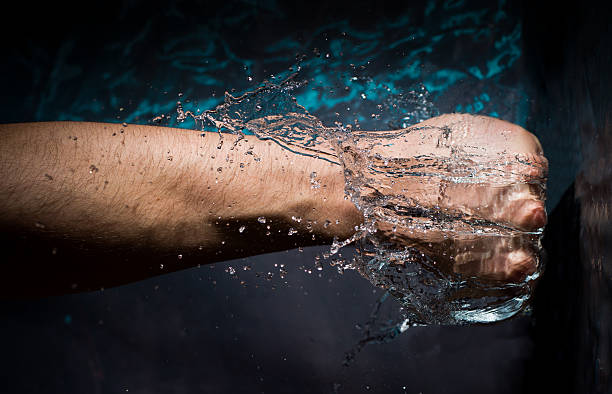istock Abstract Fist Punching Into Water 517199645