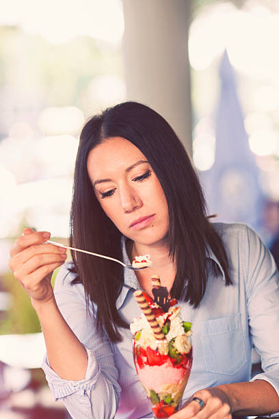 istock Sad woman consoling herself with ice cream 517201437