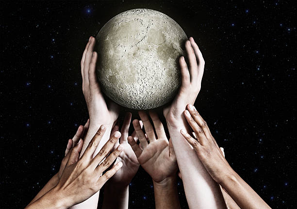 istock Many hands carefully carry the Moon 517218093