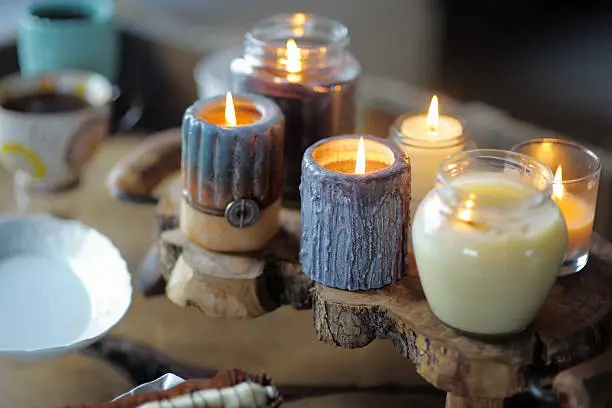 Beautiful ablaze candle on the wooden table