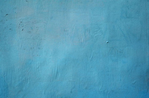 istock Texture of old wall covered with blue stucco 517221361