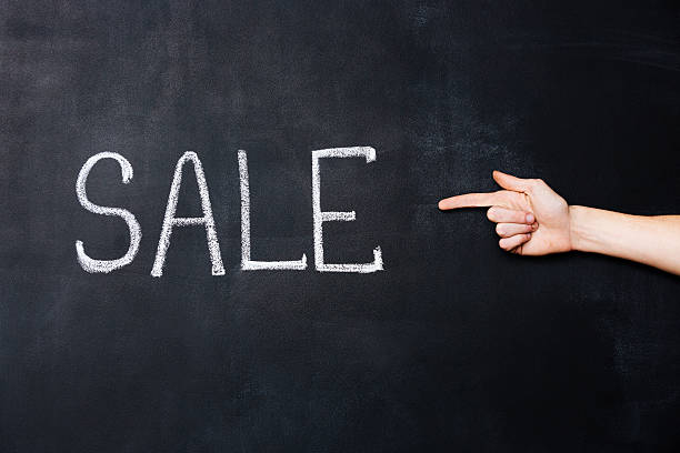 istock Hand pointing at sale written on blackboard 517221804