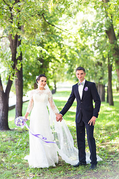 istock Elegant bride and groom posing together outdoors on a wedding 517221948