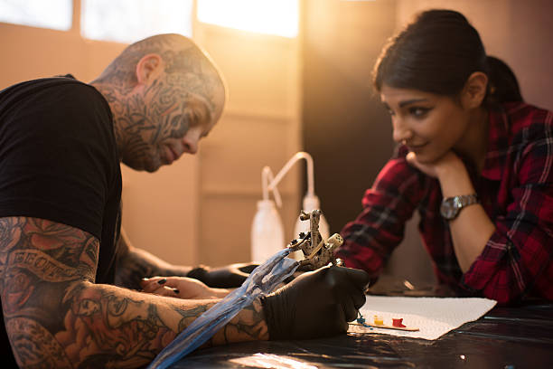istock Tattoo artist and his customer during tattooing. 517221998