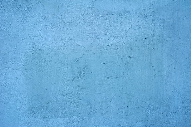istock Texture of old wall covered with blue stucco 517222355
