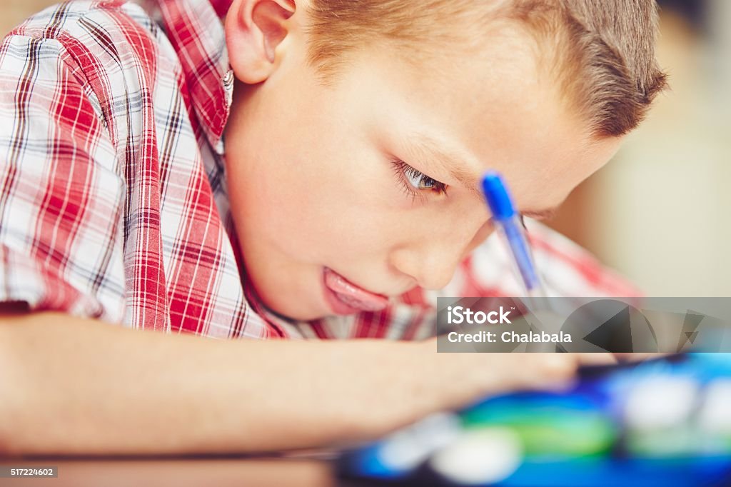 Little boy is doing homework Little boy is doing his homework for elementary school. Homework Stock Photo