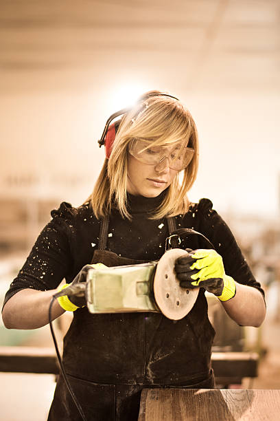 istock Blonde woman with power sander 517224612