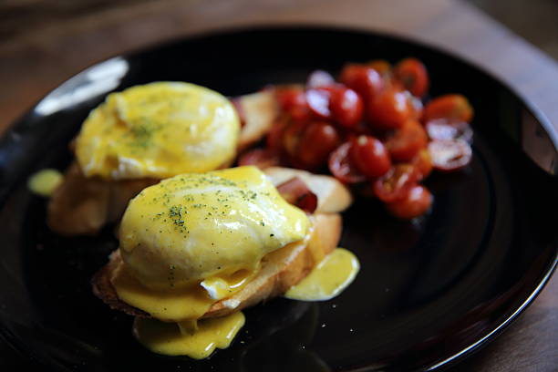 istock egg benedict in close up on wood background 517224670