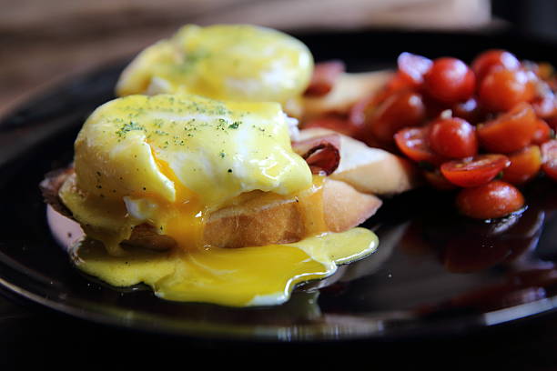 istock egg benedict in close up on wood background 517224894
