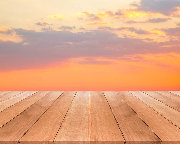 istock wood plank and sunset or sunrise with beautiful sky background 517225276