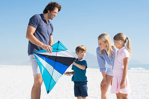 istock Family playing with kite 517225460
