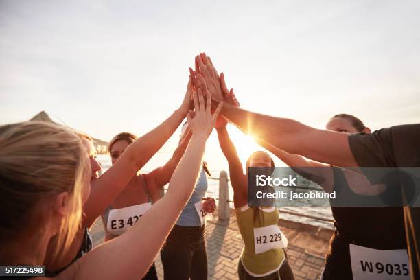 Marathon Runners Giving High Five Stock Photo - Download Image Now - Sports Team, Teamwork, Sport