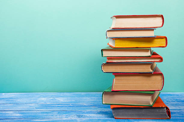 istock Stack of hardback books on wooden table. Back to school 517227764
