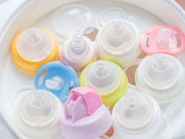 istock Nipple teethers and milk bottles in steam sterilizer and dryer. 517227972