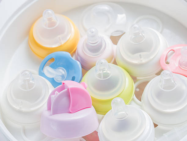 istock Nipple teethers and milk bottles in steam sterilizer and dryer. 517228022