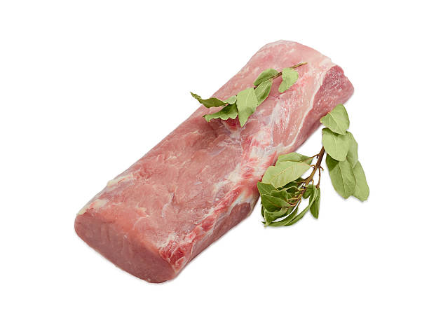 istock Uncooked pork tenderloin and bay leaf on light background 517230646