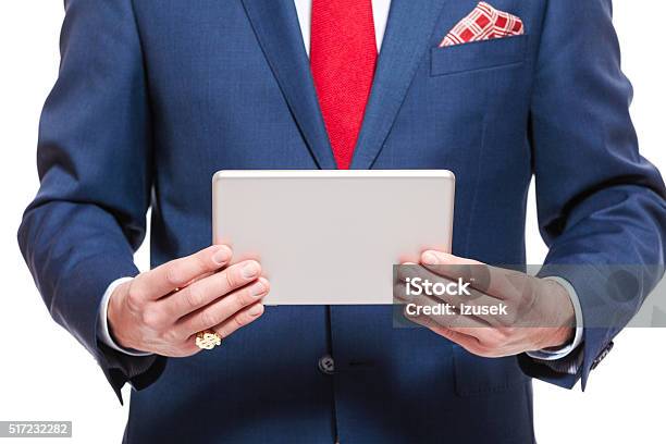 Elegant Businessman Wearing Suit Holding A Digital Tablet Stock Photo - Download Image Now