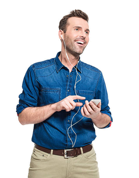 istock Happy man wearing earphone, holding smart phone 517232986