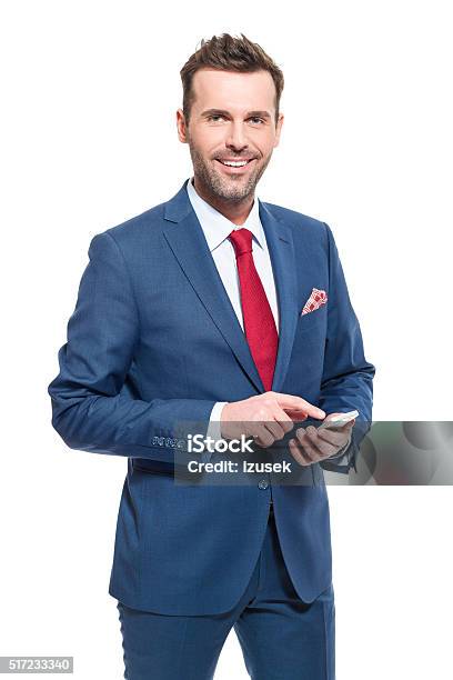 Charming Businessman Wearing Suit Using A Smart Phone Stock Photo - Download Image Now