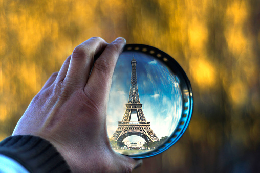Picture of a Hand hold magnifying glass with souvenir of Eifell tower