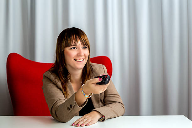 istock Elegant businesswoman at office using remote control 517233784