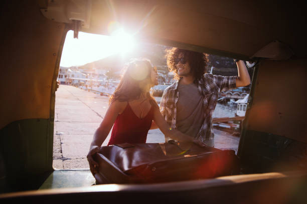 istock Young couple taking a suitcase from their vintage van 517233844