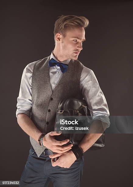 Confident Young Businessman Wearing Tweed Jacket Holding Briefcase Stock Photo - Download Image Now