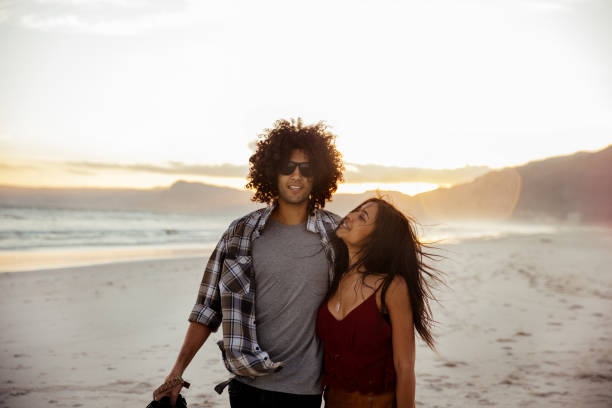 istock Hipster young couple have a romantic walk on the beach 517234482