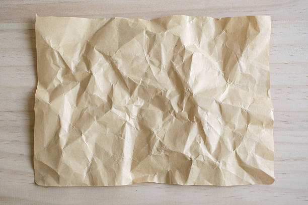istock Blank crumpled paper on wooden background 517234628