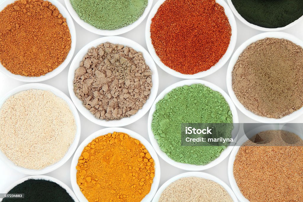 Health Food Powders Health food powder superfood selection in white porcelain bowls. Protein Stock Photo