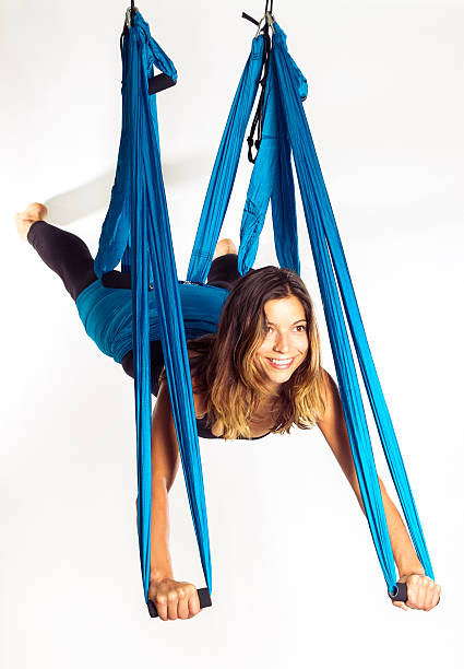 Young woman doing anti-gravity aerial yoga in hammock stock photo