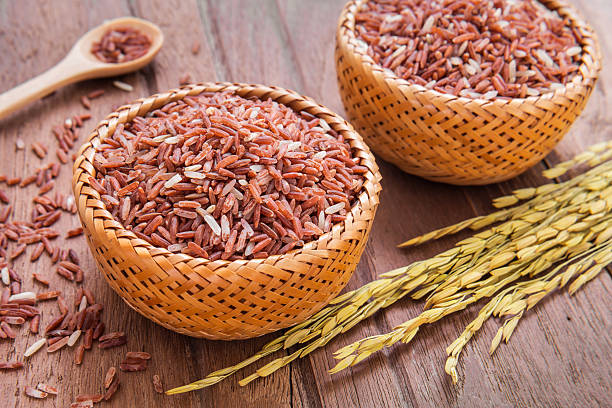 Red rice in wooden bowl