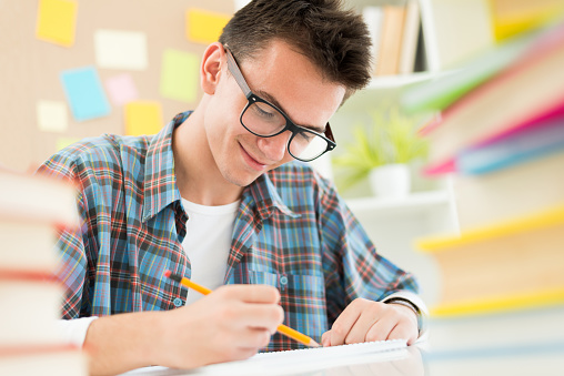 Teenage student sitting at desk and study