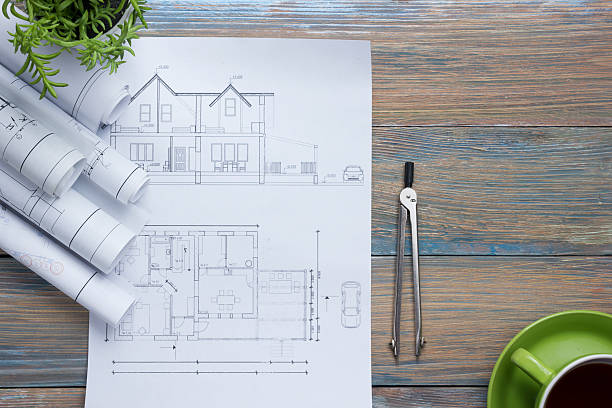 istock Architect worplace top view. Architectural project, blueprints, blueprint rolls and 517236898