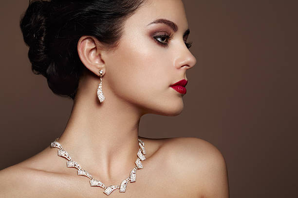 Fashion portrait of young beautiful woman with jewelry. Fashion portrait of young beautiful woman with jewelry. Brunette girl. Perfect make-up.  Beauty style woman with diamond accessories earring stock pictures, royalty-free photos & images