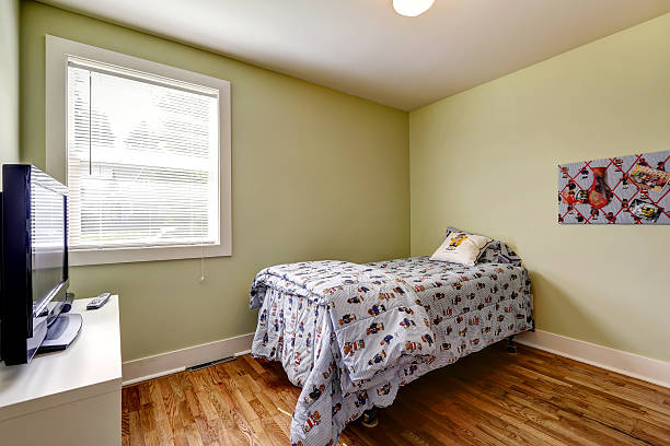 istock Simple bedroom interior with single bed and TV 517237177