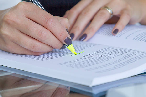 istock Young female studying and making selection in a book 517237645