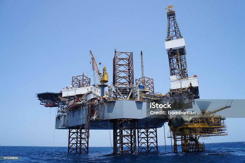 Offshore Jack Up Rig and The Production Platform Offshore Jack Up Rig and The Production Platform in The Middle of The Sea Blue Stock Photo