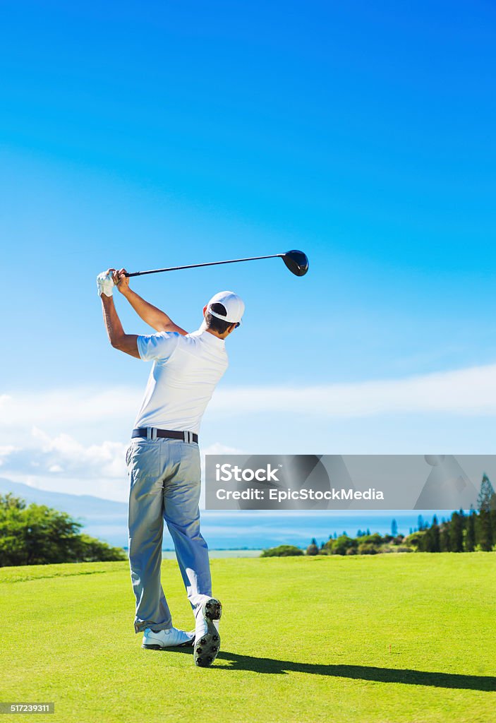 Man Playing Golf, Hitting Ball from the Tee Golfer Hitting Ball with Club on Beautiful Golf Course Golf Stock Photo