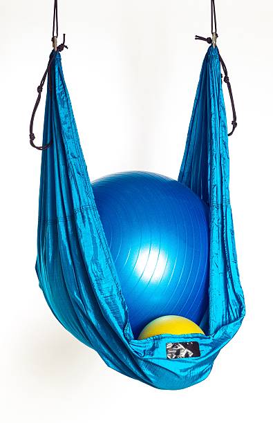 Hammock with gym balls for anti-gravity yoga exercises stock photo