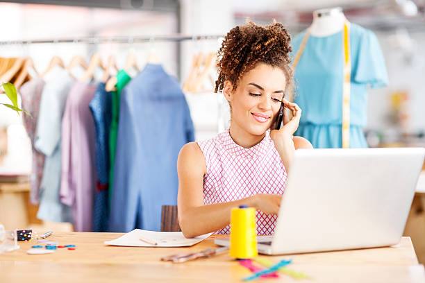 istock Designer Answering Smart Phone While Using Laptop In Fashion Stu 517239923