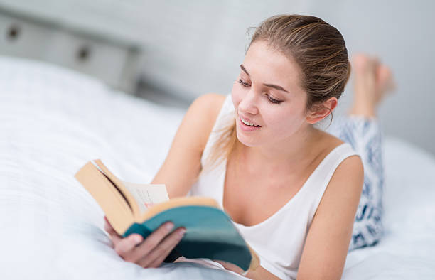 istock Woman reading in bed 517239945