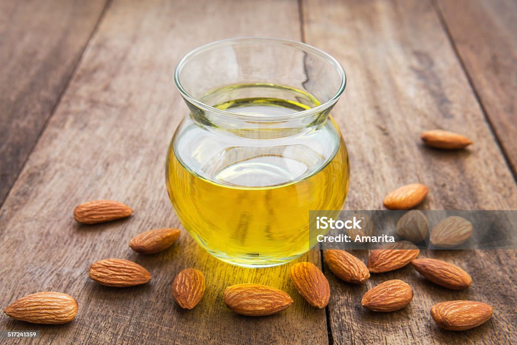 Almond oil in glass bottle and almonds Almond Stock Photo