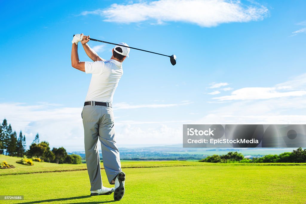 Man Playing Golf Man Playing Golf on Beautiful Sunny Green Golf Course. Hitting Golf Ball down the Fairway from the Tee with Driver. 18th Century Stock Photo