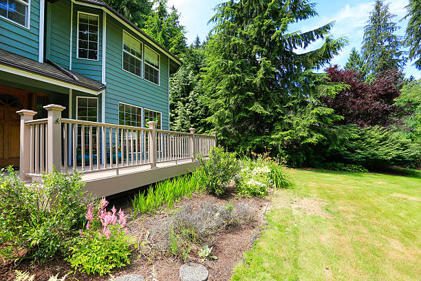 istock House with large walkout deck overlooking backyard landscape 517241675