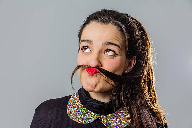 istock Real girl with red lips using her hair like a 517249423