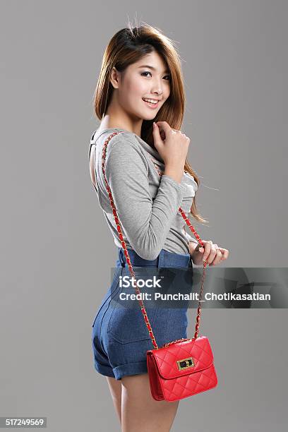 Asian Woman Pose In Long Sleeve Top And Denim Shorts Stock Photo - Download Image Now