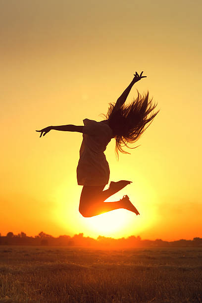 istock Girl jumping in the sunset 517249689