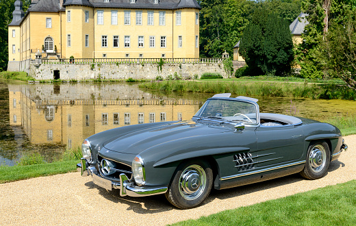 Jüchen, Germany - August 1, 2014: 1957 Mercedes-Benz 300SL Convertible parked in front of Dyck castle. The car is on display during the 2014 Classic Days event at Schloss Dyck